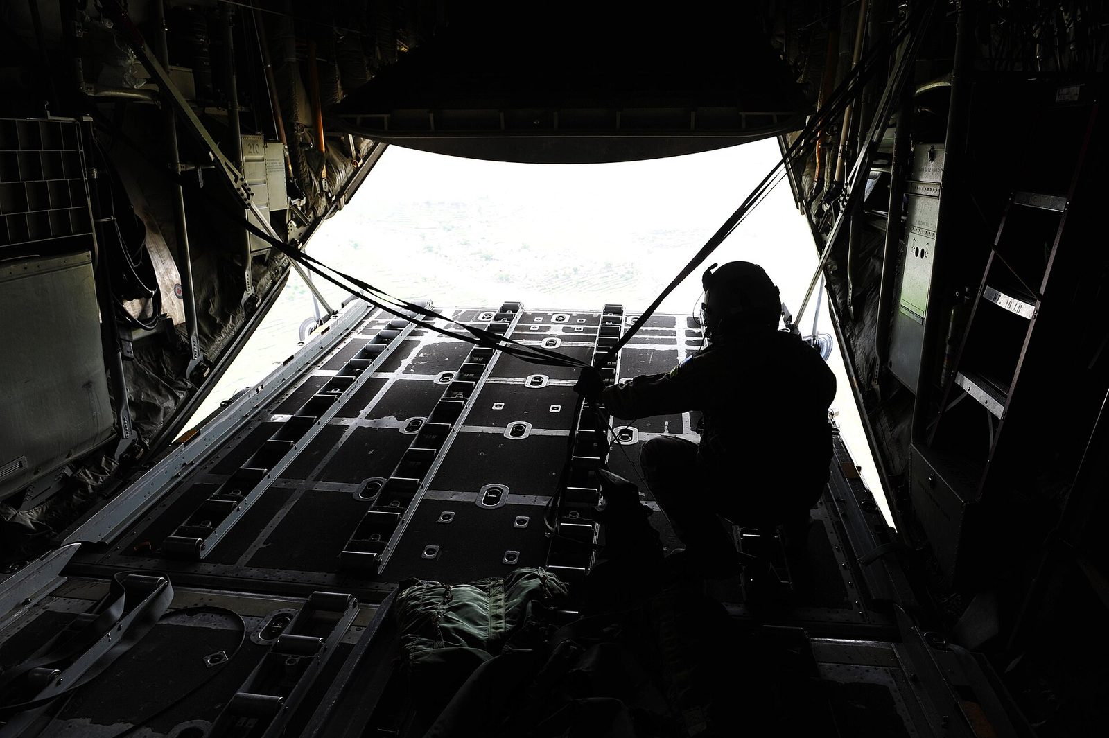 Cargo pallets under parachutes after an airdrop from a C-130